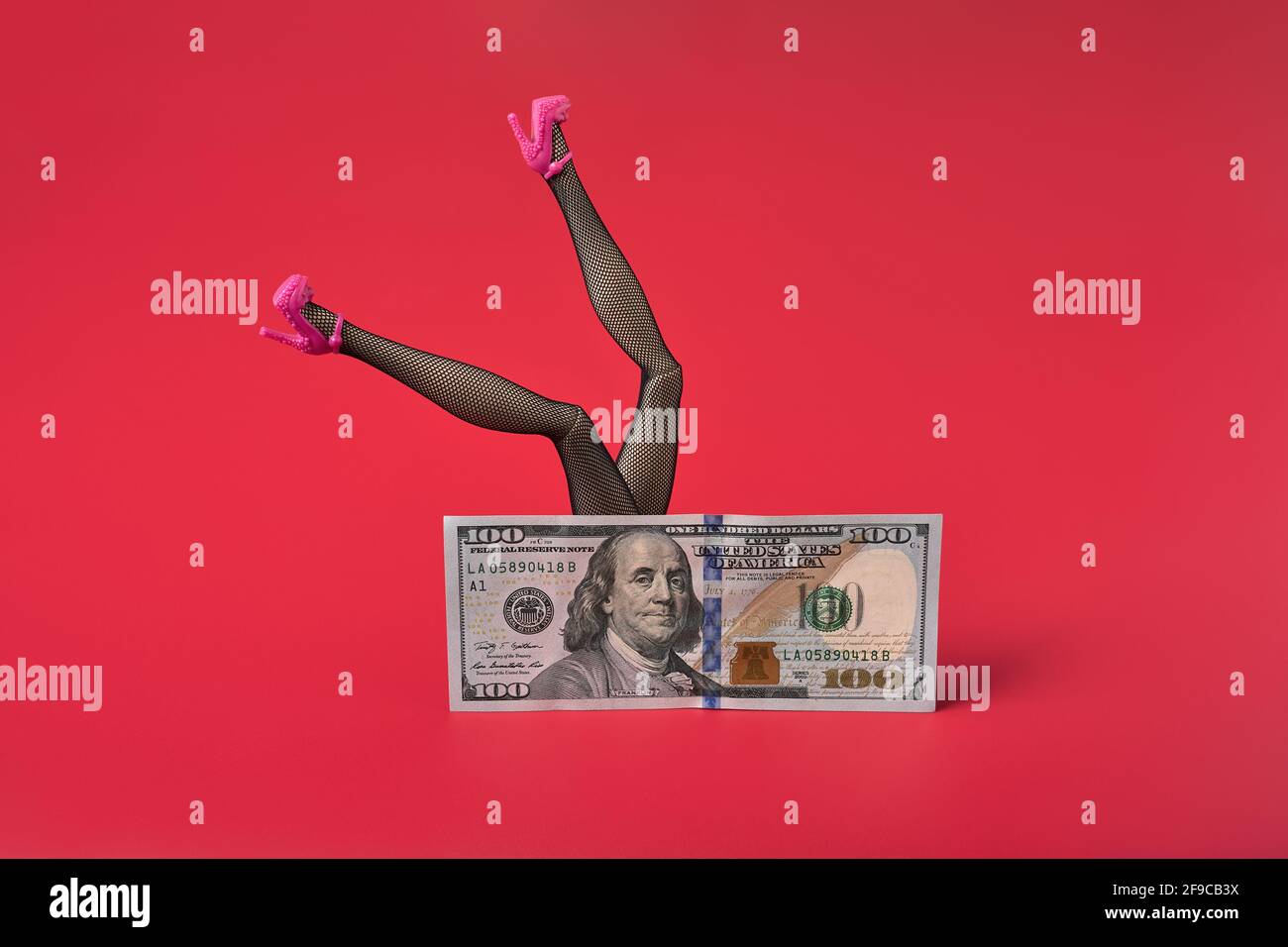 Sexy woman legs in black fishnet stockings over dollar bill, Sex for money  concept Stock Photo