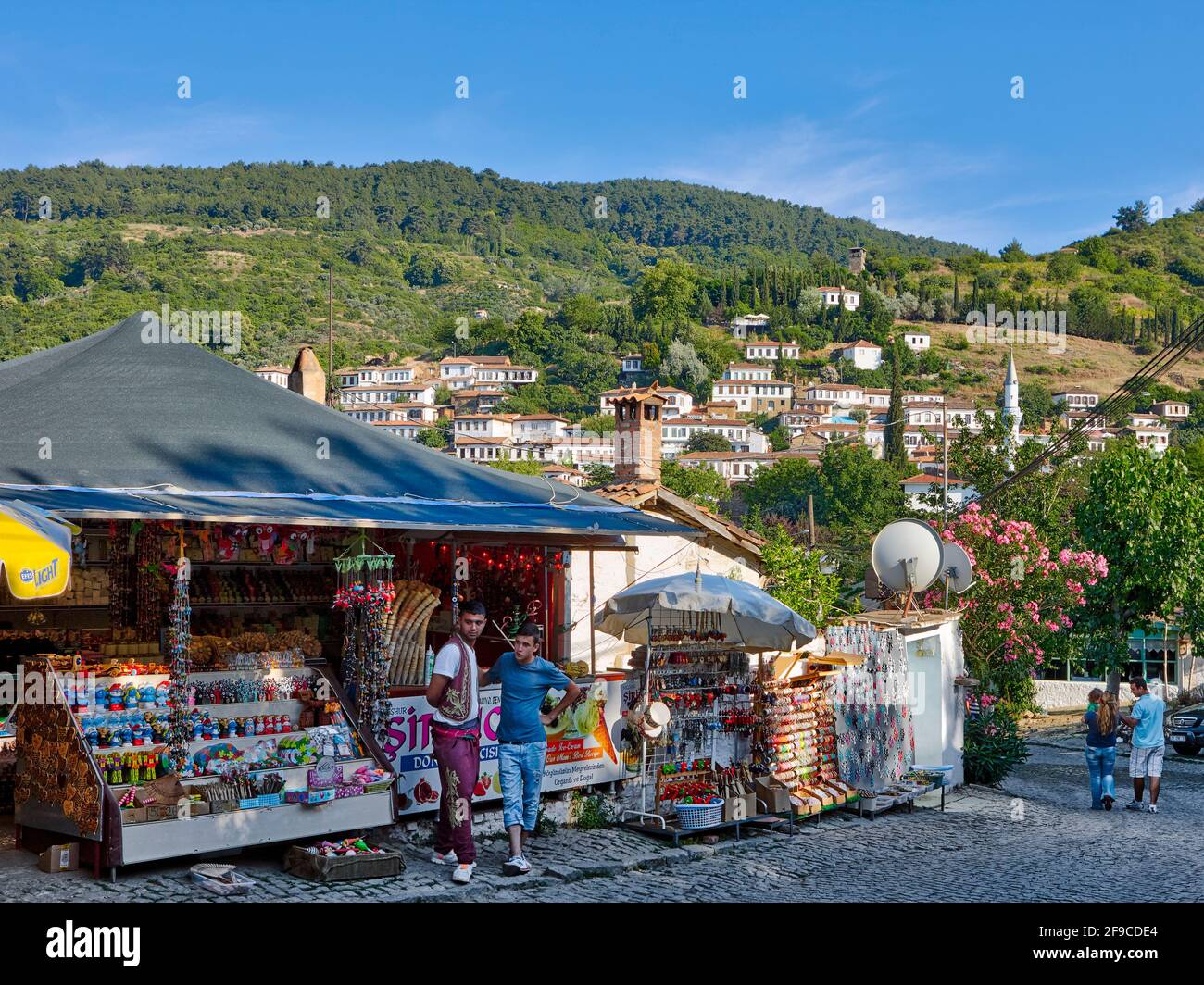 Street vendors stand near their stalls selling local souvenirs. Sirince (Şirince) village, Izmir province, Turkey. Stock Photo