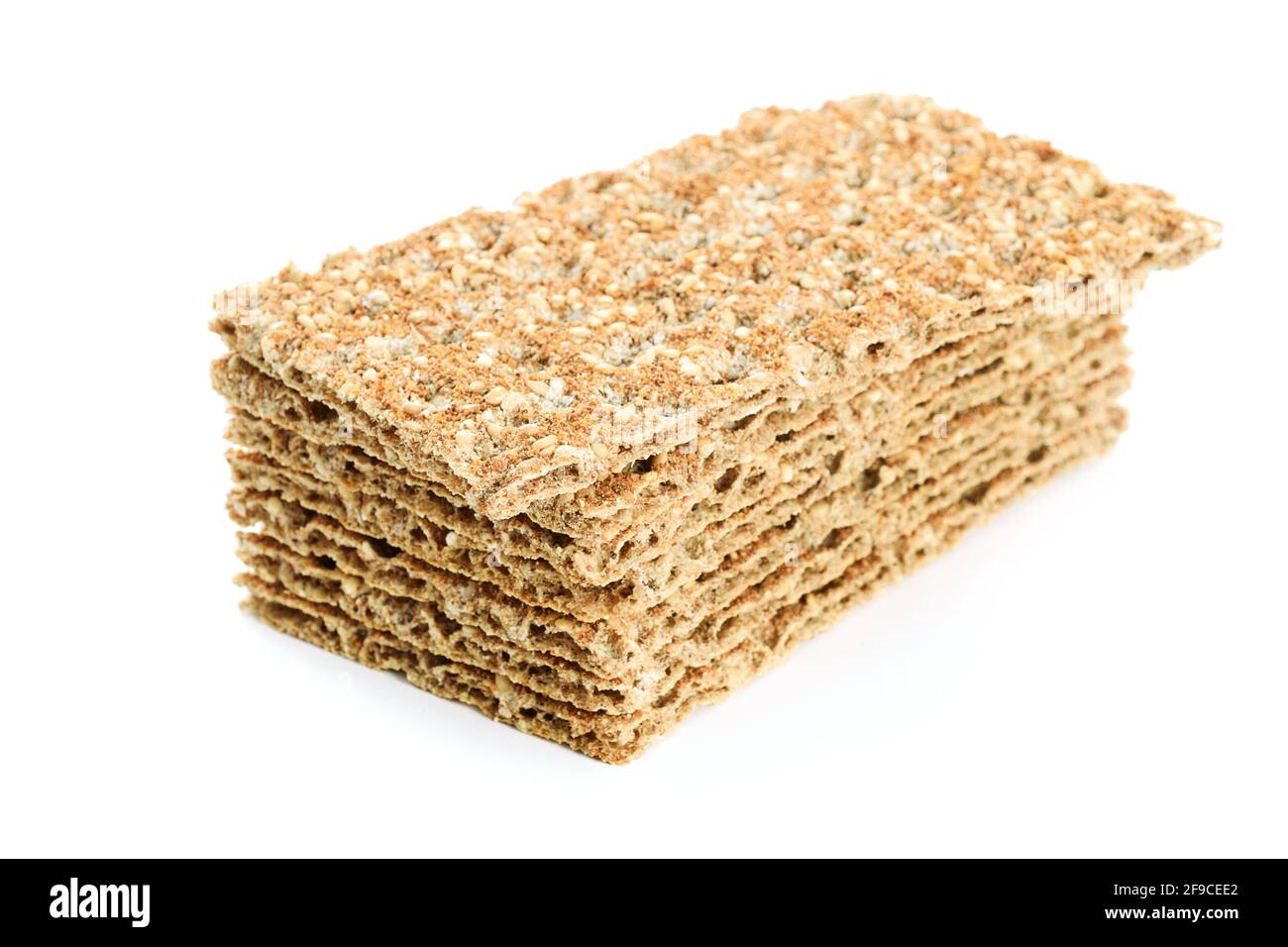 Stack of whole grain dry crispy bread with sesame isolated on a white background in close-up Stock Photo