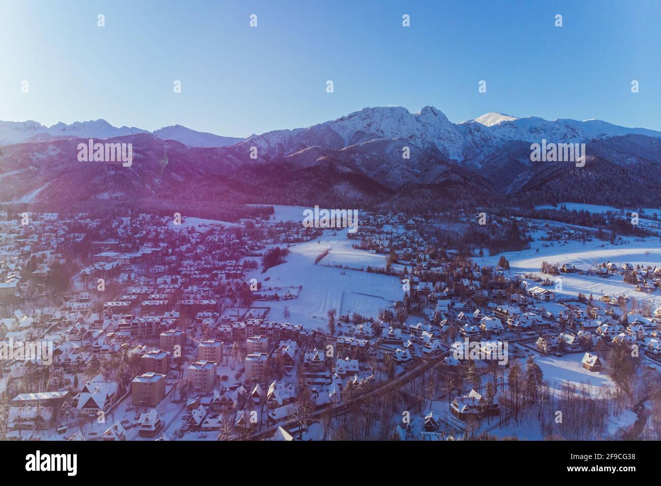 Cold morning over Zakopane town in Poland covered in snow with Mountains in the background. Aerial. High quality 4k footage Stock Photo