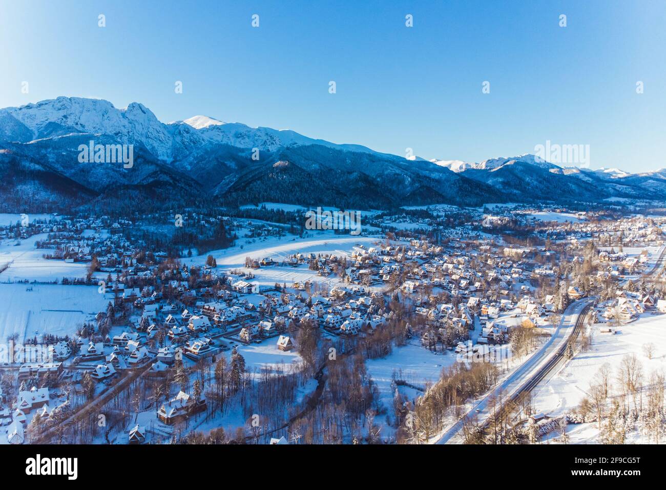 Cold morning over Zakopane town in Poland covered in snow with Mountains in the background. Aerial. High quality 4k footage Stock Photo