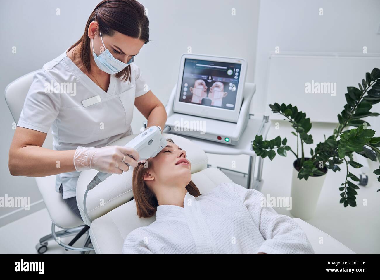 Woman receiving face ultrasound hi-res stock photography and images - Alamy