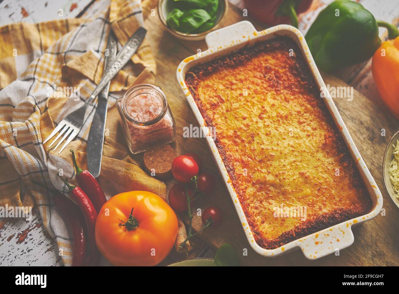 Tasty traditional italian lasagna with bolognese, melted and cheese. Served with ingredients Stock Photo