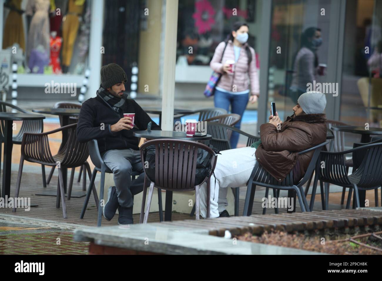 Sofia, Bulgaria - Apr 4 2021: Two men drinking coffee outside Stock Photo
