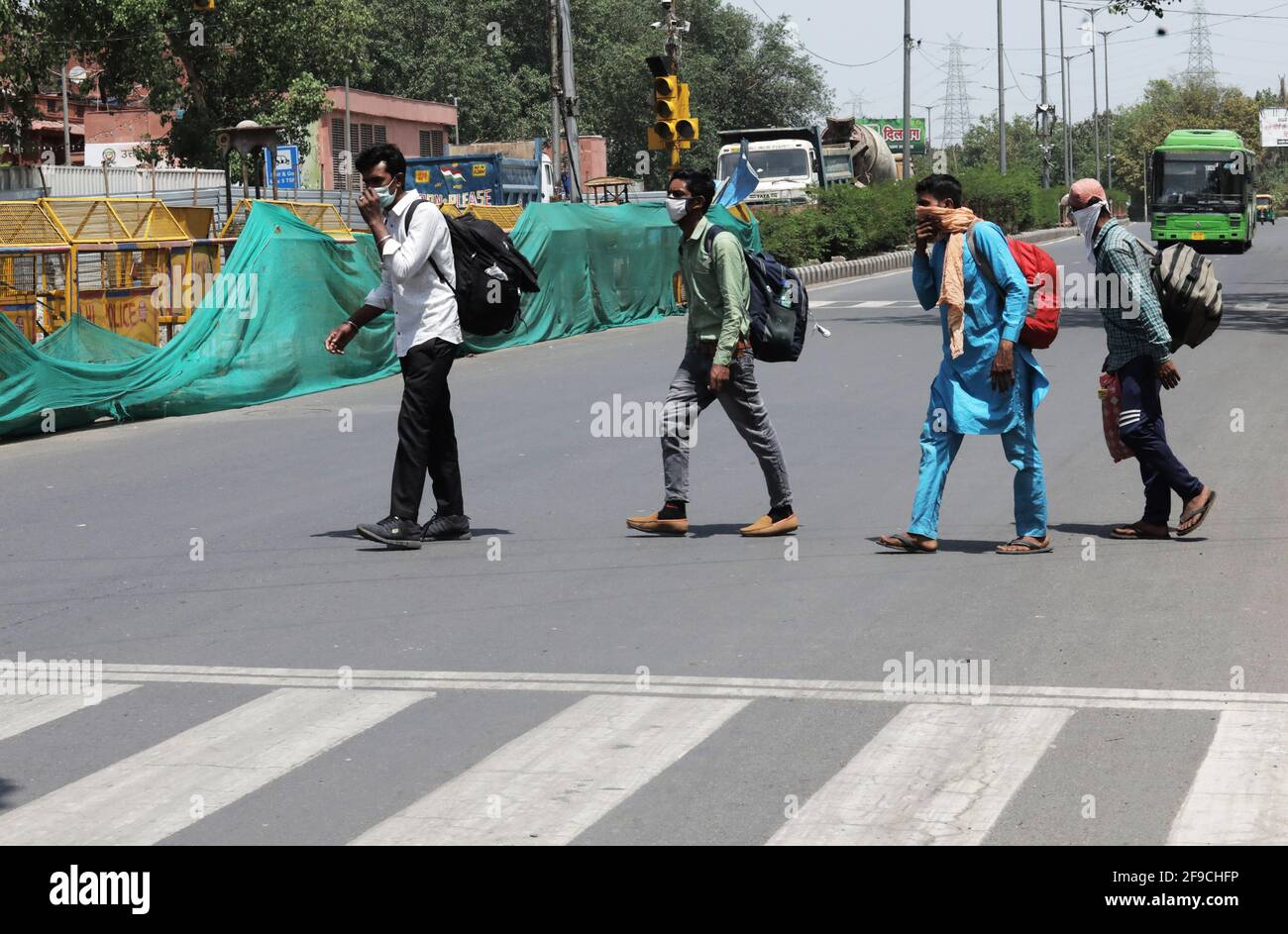 New Delhi, India. 17th Apr, 2021. Migrant workers walk towards Chandni Chowk area as they return to their native places amid fears of a total lockdown during the weekend lockdown.The alarming situation this weekend lockdown was imposed to fight Covid-19 cases. Delhi and other state governments imposed partial restrictions on weekend lockdowns and night curfews. People remained confined to their homes so that they could break the chain of coronavirus transmission. India has reported a record 217,353 new cases on Friday. Credit: SOPA Images Limited/Alamy Live News Stock Photo