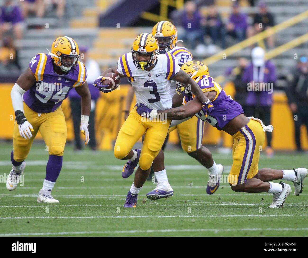 Baton Rouge, LA, USA. 17th Apr, 2021. LSU's Tyrion Davis-Price (3) looks for running room as linebacker Damone Clark (18) and Joseph Evans (94) look for a tackle during the National L Club LSU Spring Game at Tiger Stadium in Baton Rouge, LA. Jonathan Mailhes/CSM/Alamy Live News Stock Photo
