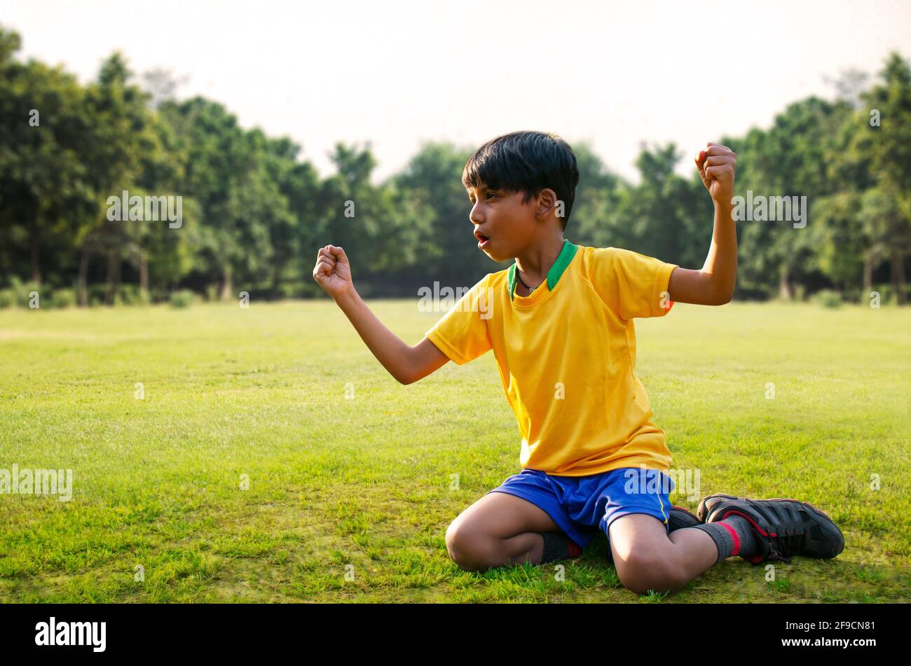 Full Length of Excited boy football player after goal scored Stock Photo