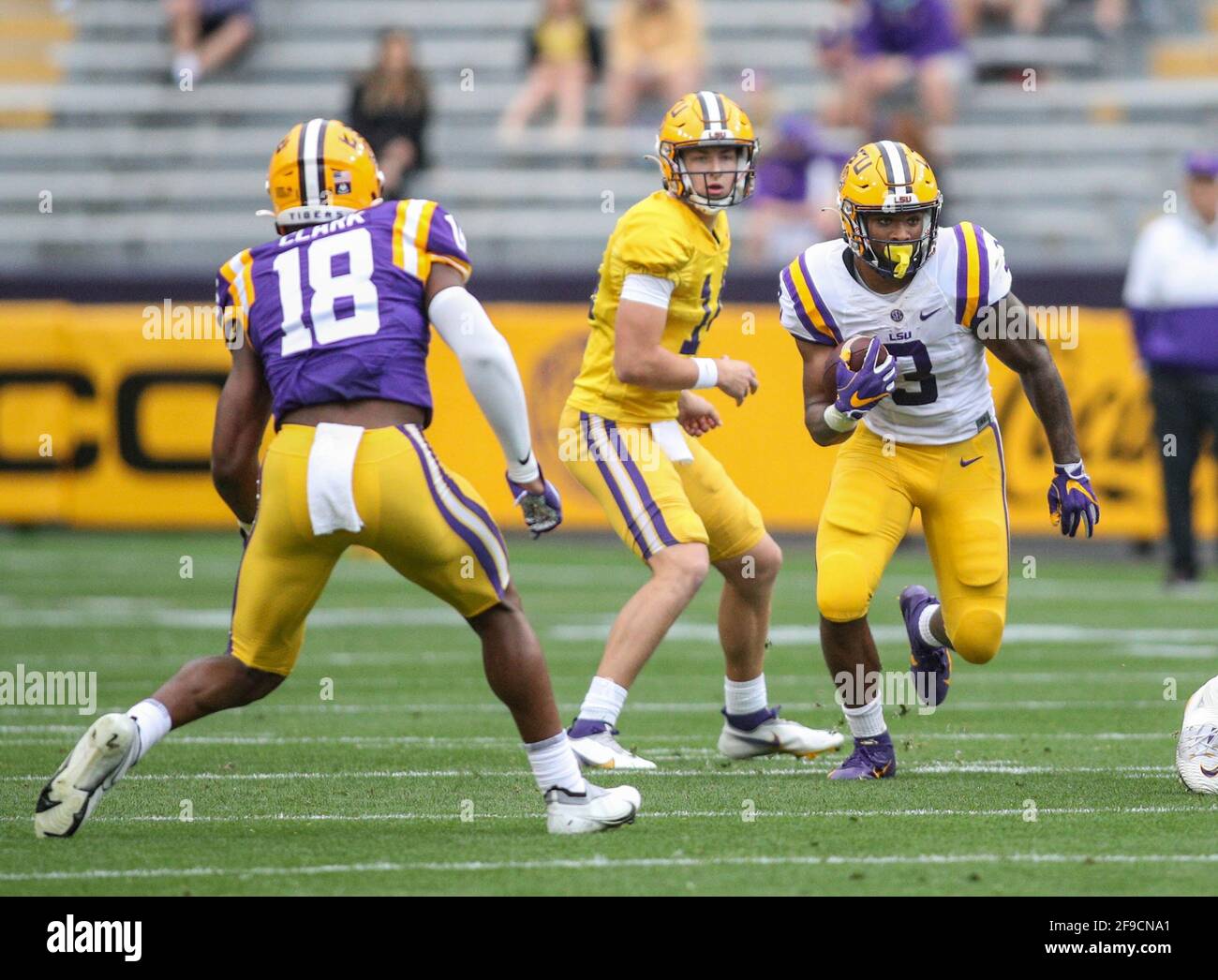 Baton Rouge, LA, USA. 17th Apr, 2021. LSU's Tyrion Davis-Price (3) looks for running room as linebacker Damone Clark (18) looks for a tackle during the National L Club LSU Spring Game at Tiger Stadium in Baton Rouge, LA. Jonathan Mailhes/CSM/Alamy Live News Stock Photo