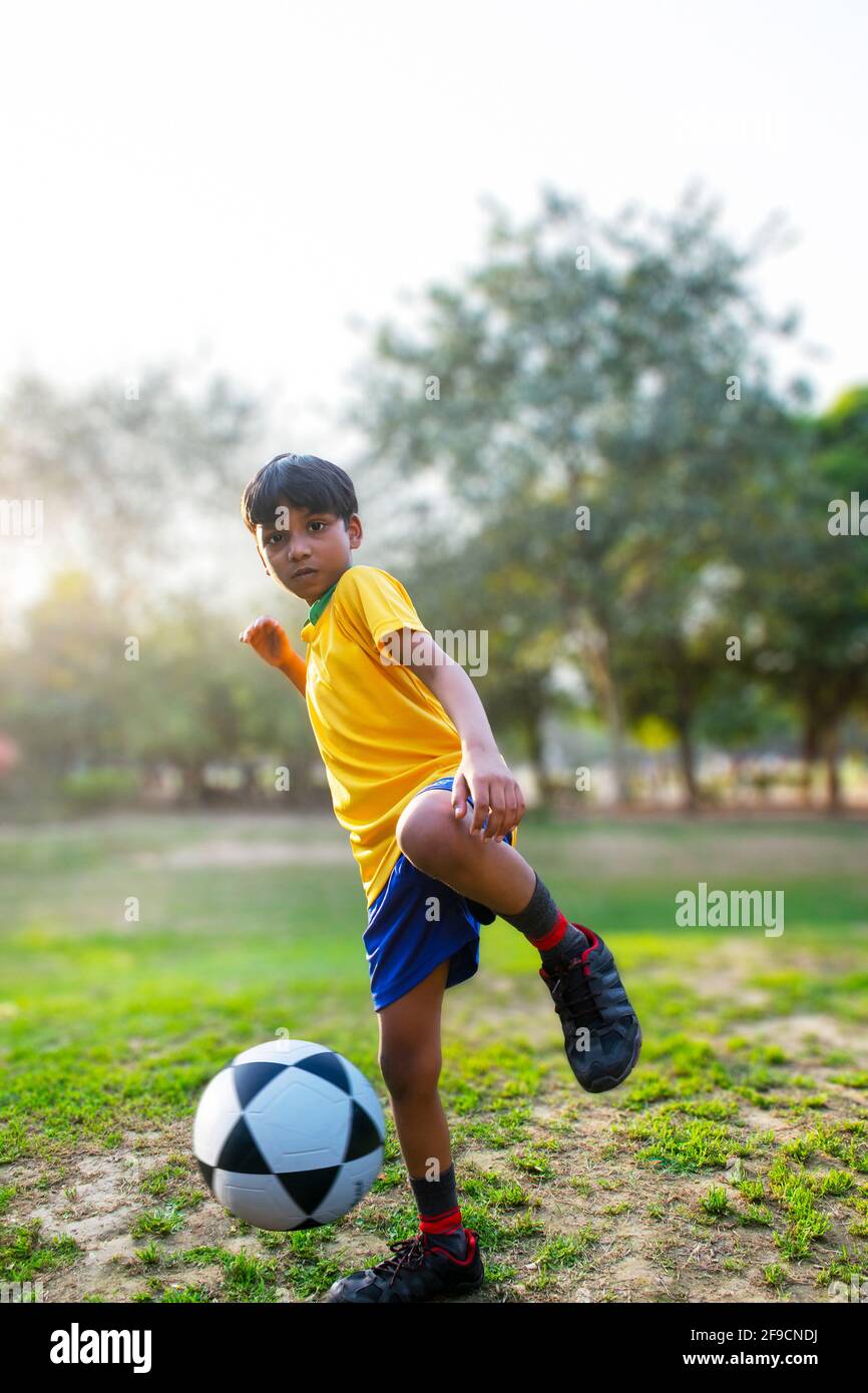Football player kicking ball Stock Photo