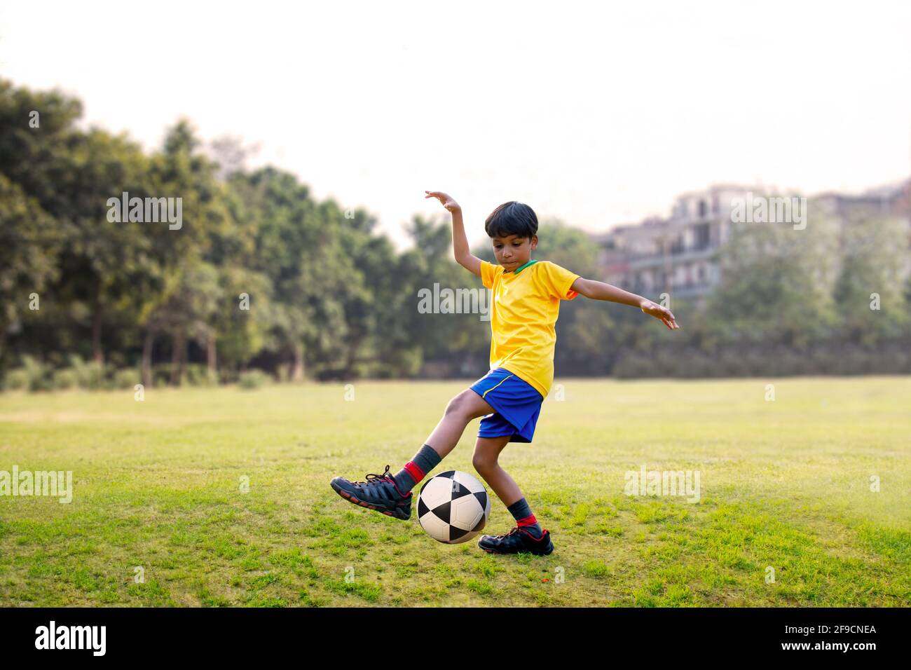 Football player kicking ball Stock Photo Alamy