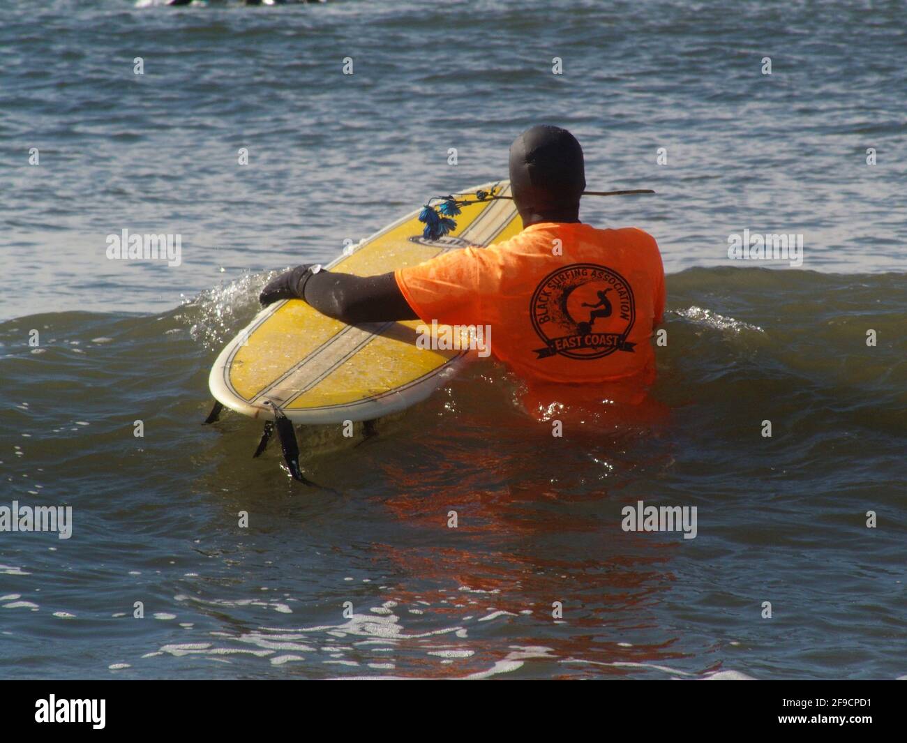 April 17, 2021, New York, New York, USA: NEW YORK -  Black Surfers Association have a paddle out to honor George Floyd and Daunte Wright in Far Rockaway Queens at Beach 91st. Street. Surfers take to the water hold a prayer circle and place flowers in the water while family members and friends hold signs on the beach. (Credit Image: © Bruce Cotler/ZUMA Wire) Stock Photo