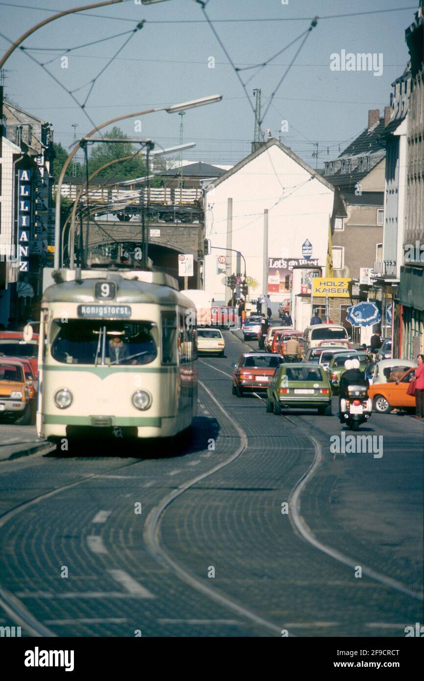 Tram running in suburban street in the 1980s, Cologne, North Rhine-Westphalia, Germany Stock Photo