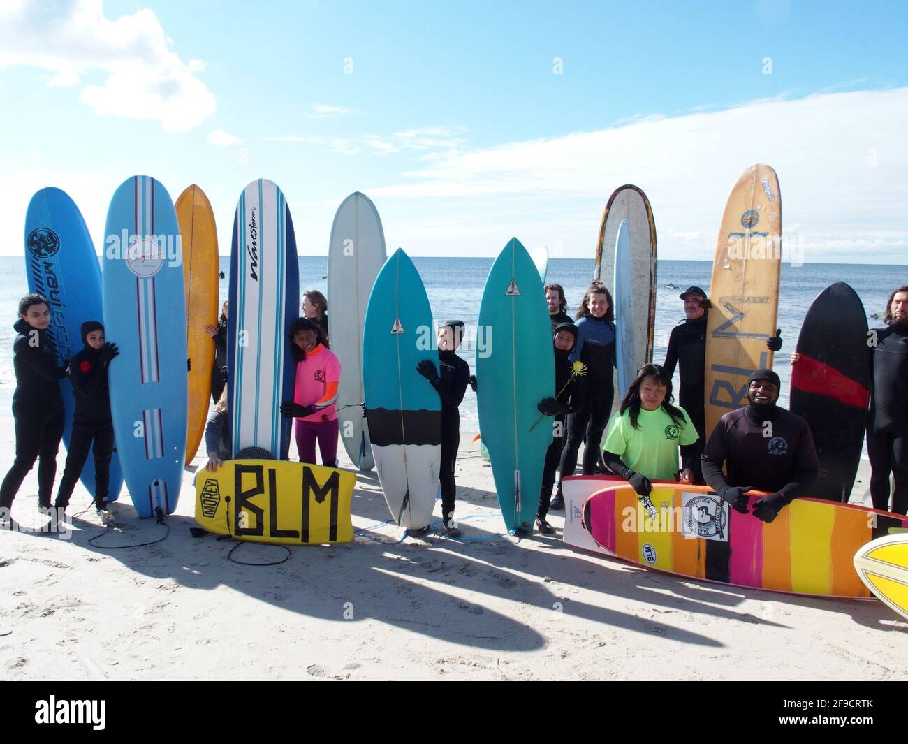 April 17, 2021, New York, New York, USA: NEW YORK -  Black Surfers Association have a paddle out to honor George Floyd and Daunte Wright in Far Rockaway Queens at Beach 91st. Street. Surfers take to the water hold a prayer circle and place flowers in the water while family members and friends hold signs on the beach. (Credit Image: © Bruce Cotler/ZUMA Wire) Stock Photo