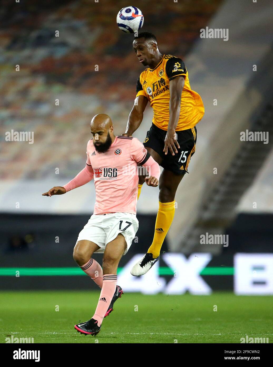 Sheffield United's David McGoldrick (left) and Wolverhampton Wanderers' Willy Boly battle for the ball during the Premier League match at Molineux, Wolverhampton. Picture date: Saturday April 17, 2021. Stock Photo