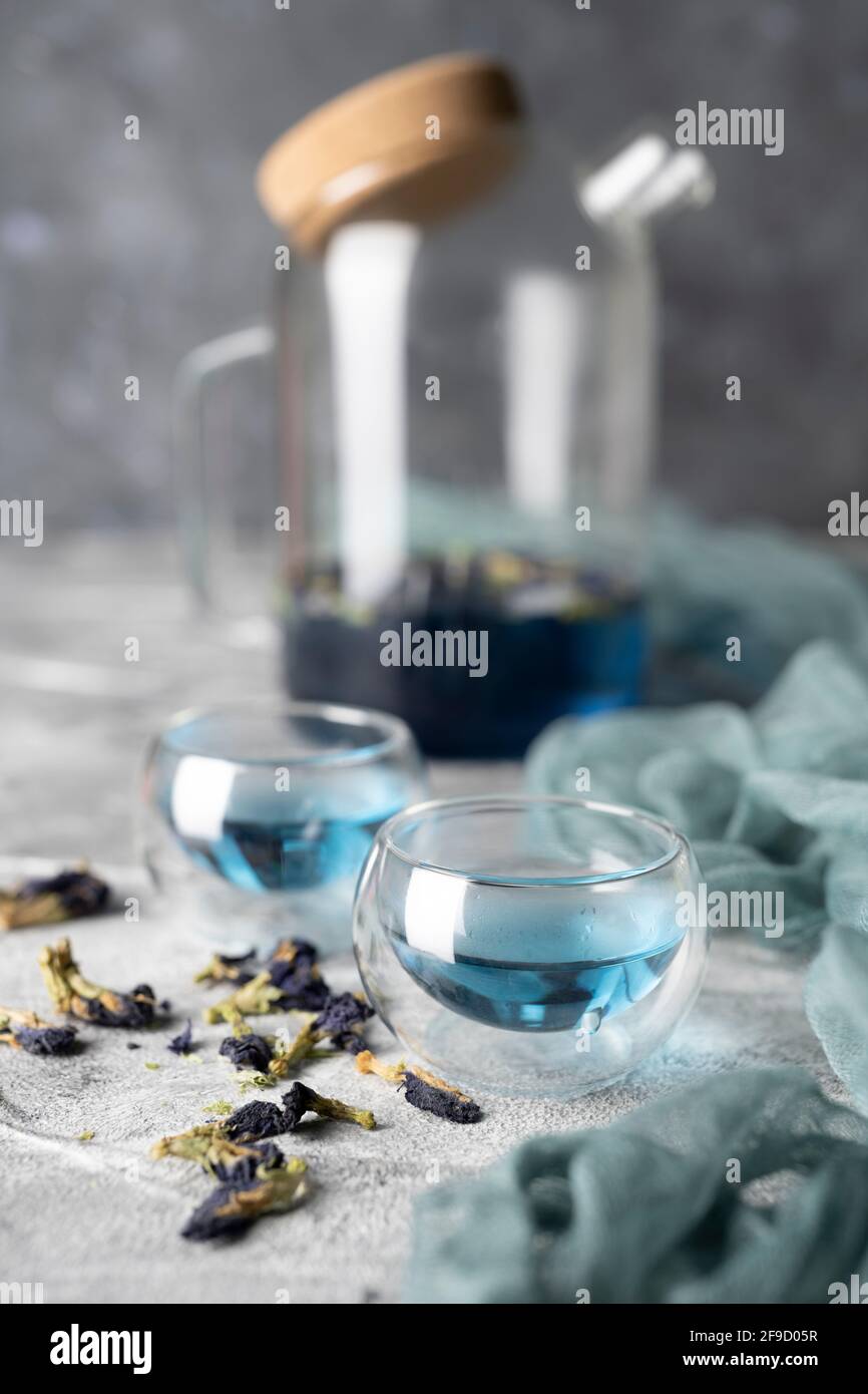 Organic blue tea Anchan, Clitoria, Butterfly Pea in a teapot and a cups ...