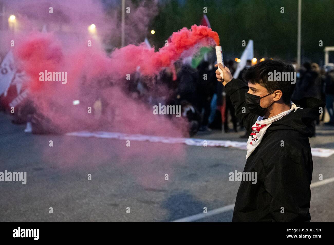 San Didero, Italy. 17 April 2021. A demonstrator holds a smoke bomb during a 'No TAV' (No to high-speed train) demonstration against Lyon-Turin high speed rail link. Credit: Nicolò Campo/Alamy Live News Stock Photo