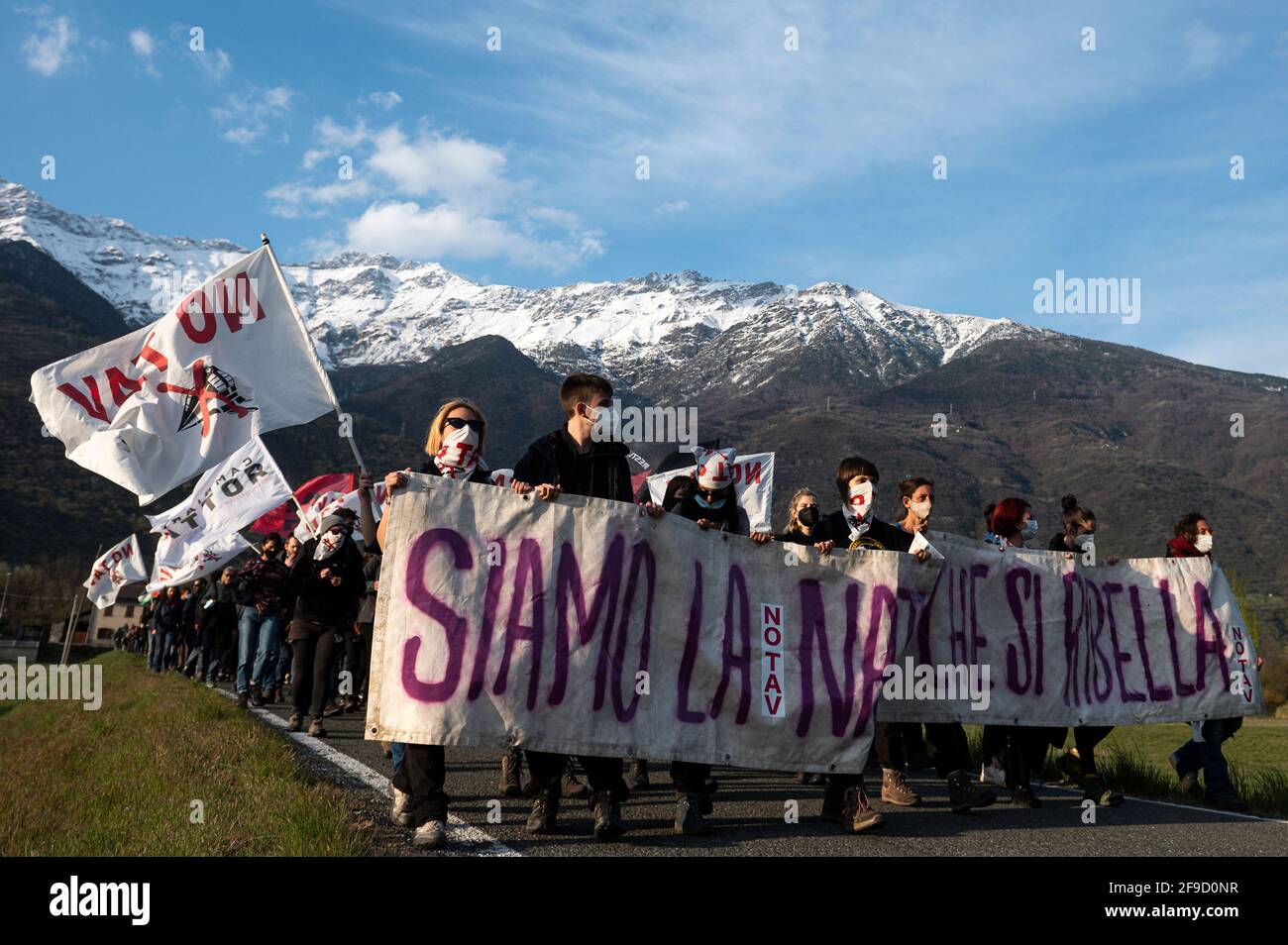 San Didero, Italy. 17 April 2021. Demonstrators hold a banner reading 'We are nature that rebels' during a 'No TAV' (No to high-speed train) demonstration against Lyon-Turin high speed rail link. Credit: Nicolò Campo/Alamy Live News Stock Photo