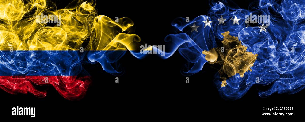 Colombia, Colombian vs Kosovo, Kosovar smoky mystic flags placed side by side. Thick colored silky abstract smokes flags. Stock Photo