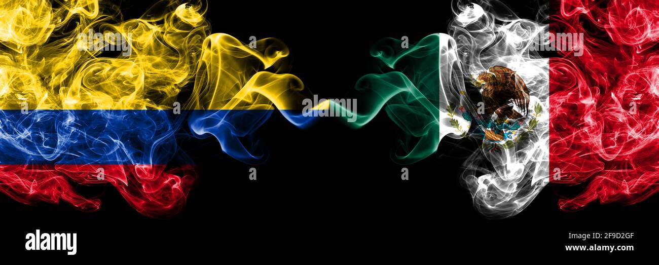 Colombia, Colombian vs Mexico, Mexican smoky mystic flags placed side by side. Thick colored silky abstract smokes flags. Stock Photo