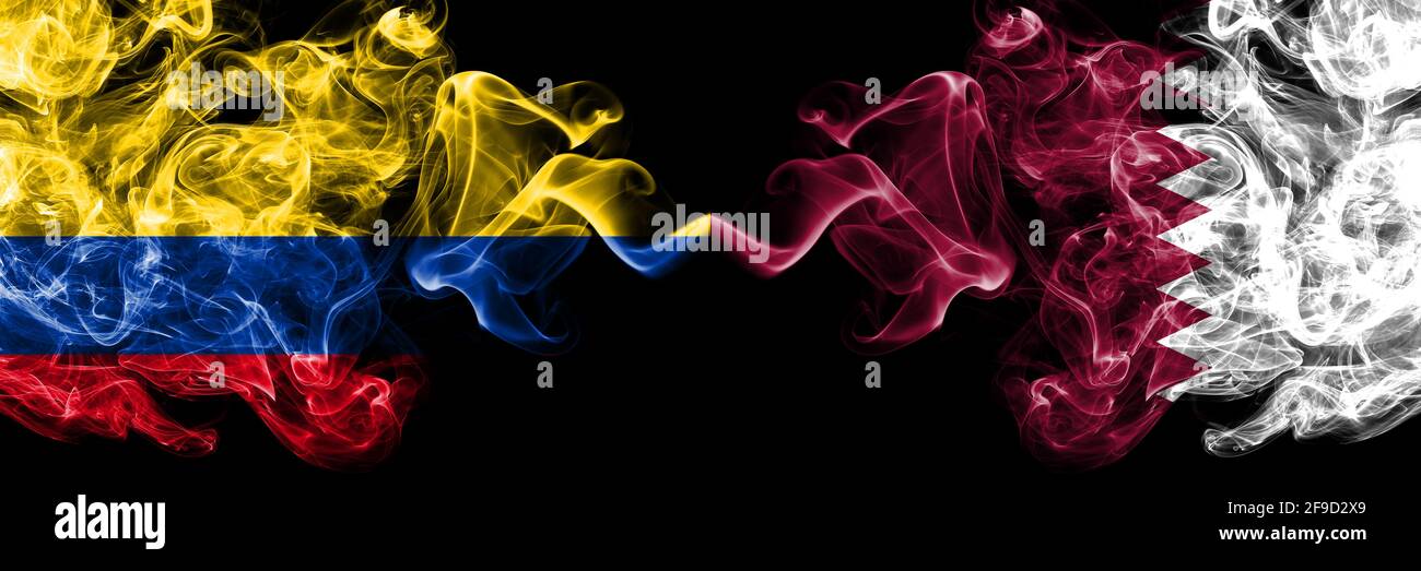 Colombia, Colombian vs Qatar, Qatari smoky mystic flags placed side by side. Thick colored silky abstract smokes flags. Stock Photo