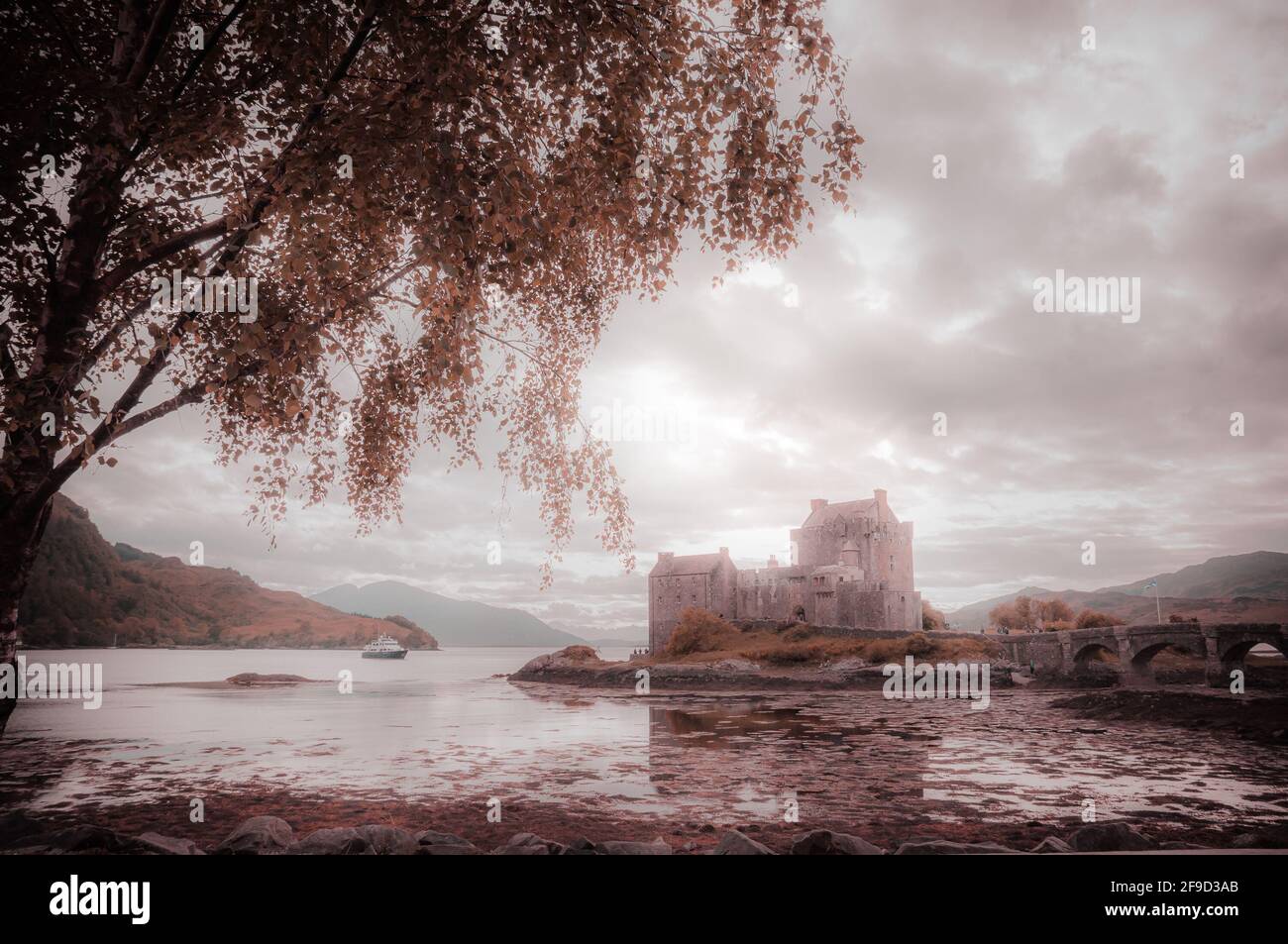 Fantasy colors panorama of Eilean Donan castle, Dornie, Scotland. Concept: fantastic and mythological places, travel to famous places in Scotland Stock Photo