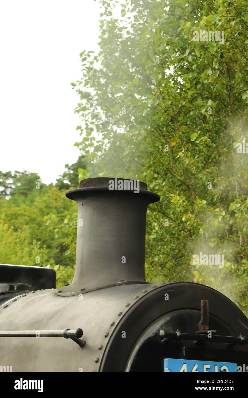 Steam locomotive full of coal running on a track through the ...