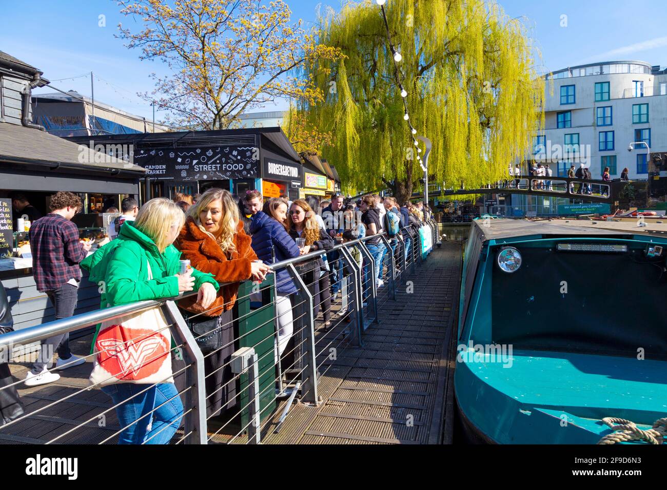 17th April 2021 - London, UK, People eating, chatting and socialising in busy Camden Market on a sunny weekend after coronavirus pandemic lockdown easing Stock Photo