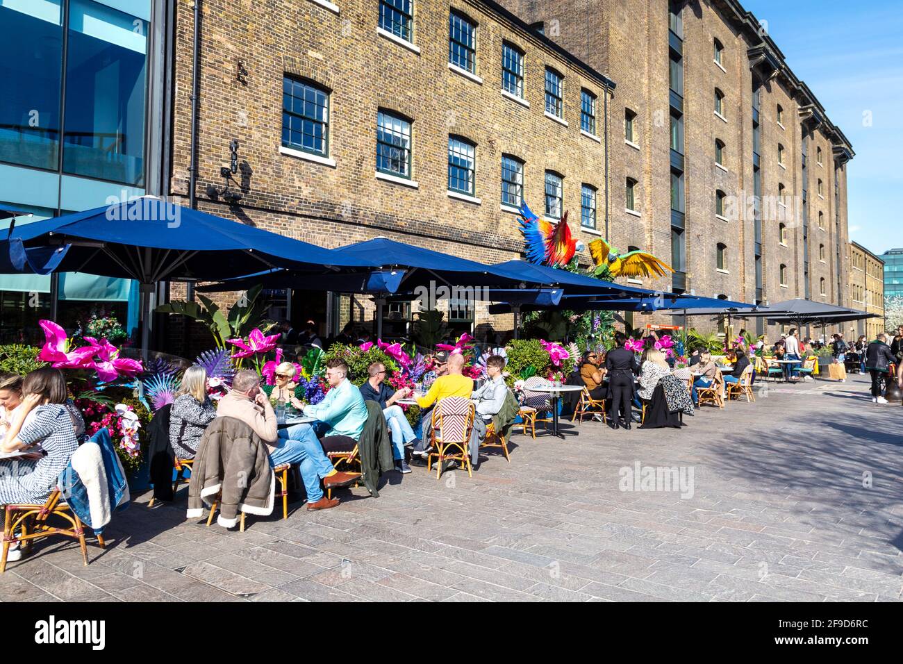 17th April 2021 - London, UK, People dining al fresco at a restaurant in Granary Square, Kings Cross on a sunny weekend after easing of coronavirus pandemic lockdown Stock Photo