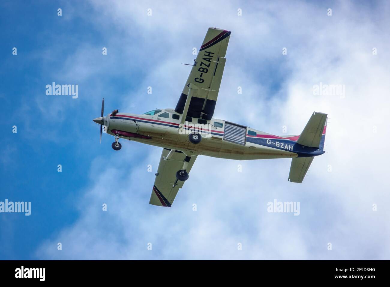 Cessna 208B Grand Caravan climbing away from the grass airfield taking