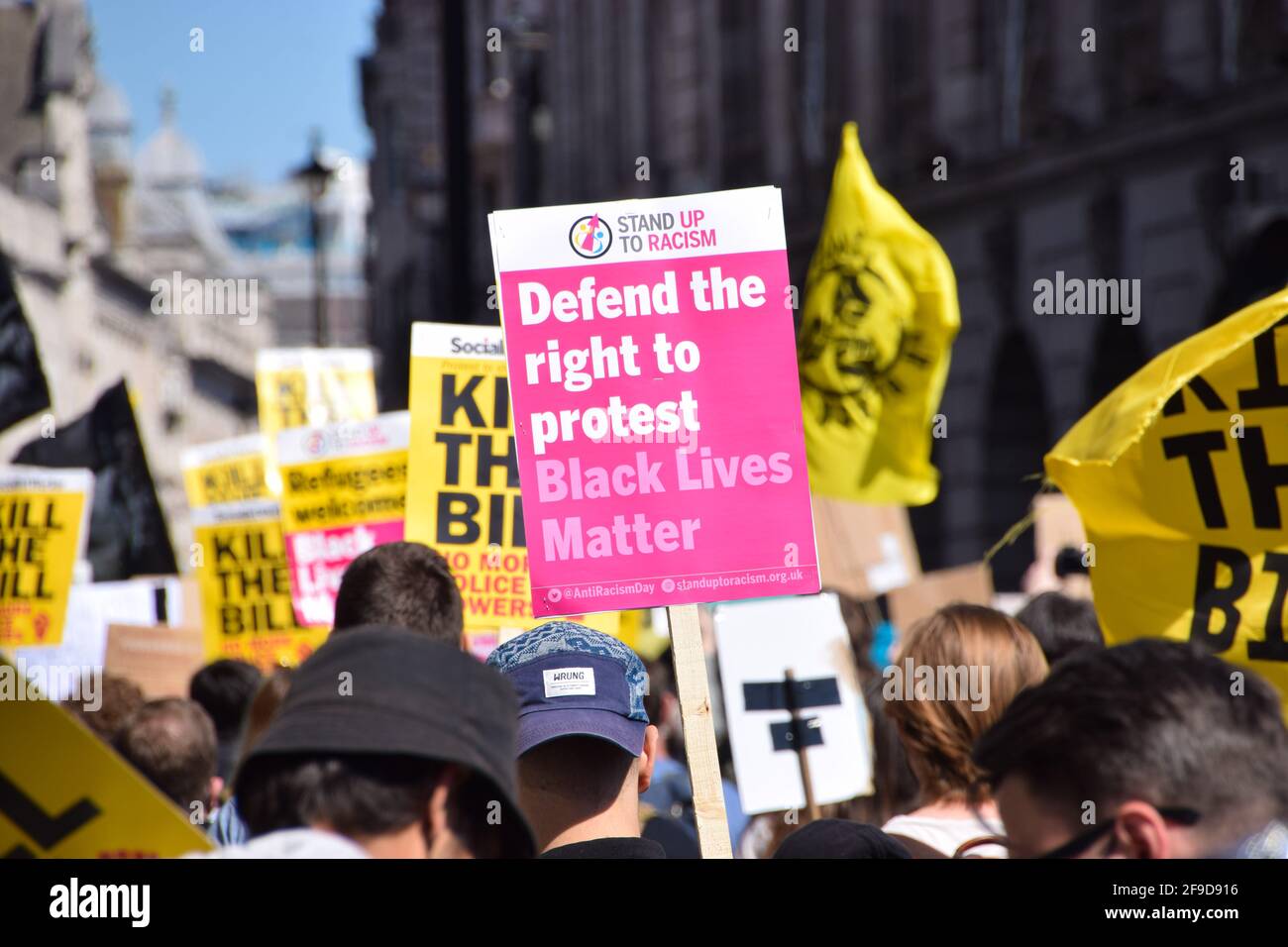 A demonstrator holds a placard that ays Defend The Right To Protest during the Kill The Bill protest in Central London.Crowds once again marched in protest against the Police, Crime, Sentencing and Courts Bill. Stock Photo