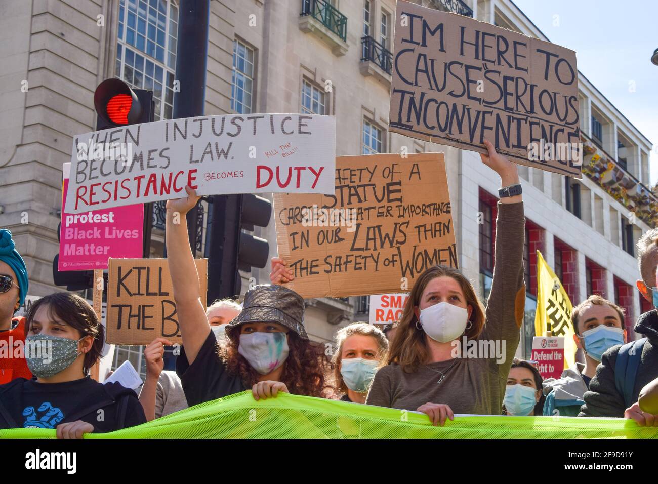Protesters hold placards during the Kill The Bill demonstration in Central London.Crowds once again marched in protest against the Police, Crime, Sentencing and Courts Bill. Stock Photo