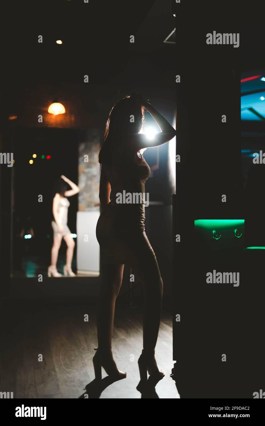 Shallow focus of a woman wearing a tight dress with high heels in the club Stock Photo - Alamy Shallow focus of a woman wearing a tight dress with high heels in the club Stock Photo - Alamy
