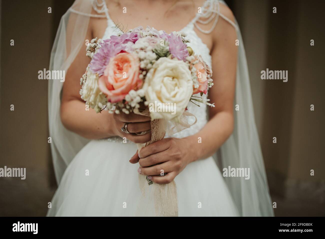 Young bride in a white wedding dress holding a wedding bouquet Stock ...