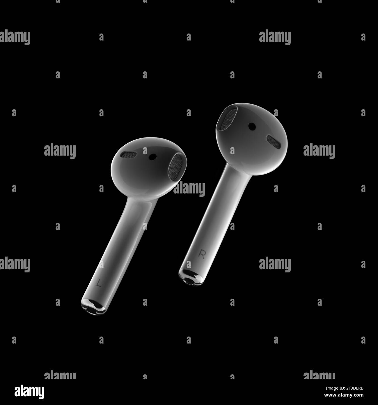 Apple 'AirPod' earphones on black background Stock Photo