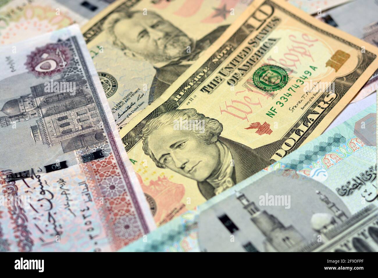 Egypt national currency with USA dollar banknote backdrop. Money