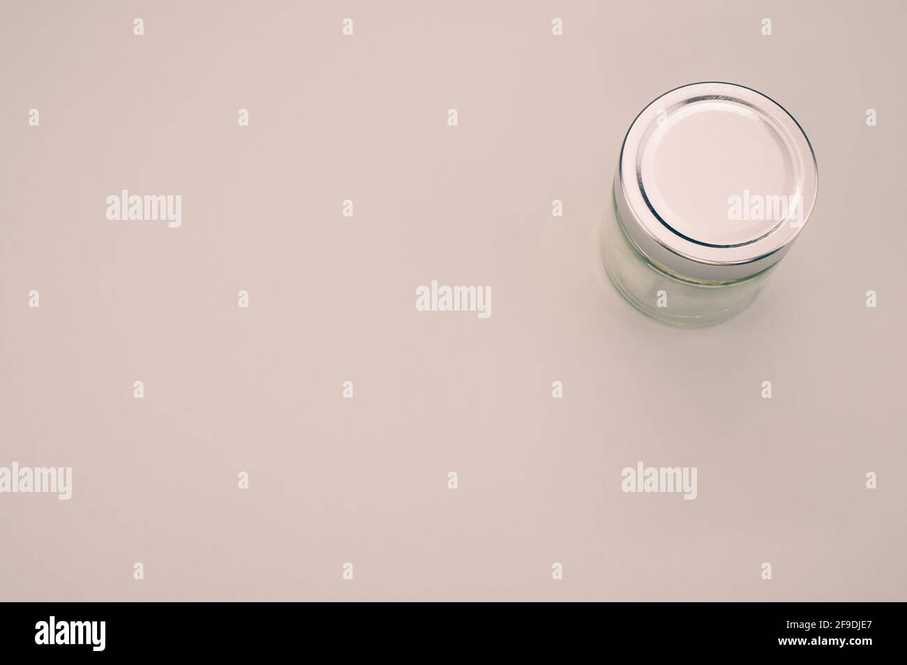 A jar with a metallic lid on a white background Stock Photo - Alamy