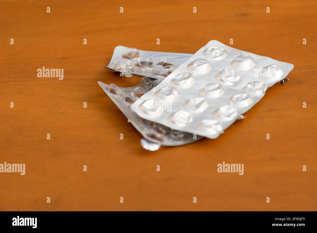 Several medicine empty pack on wooden background Stock Photo