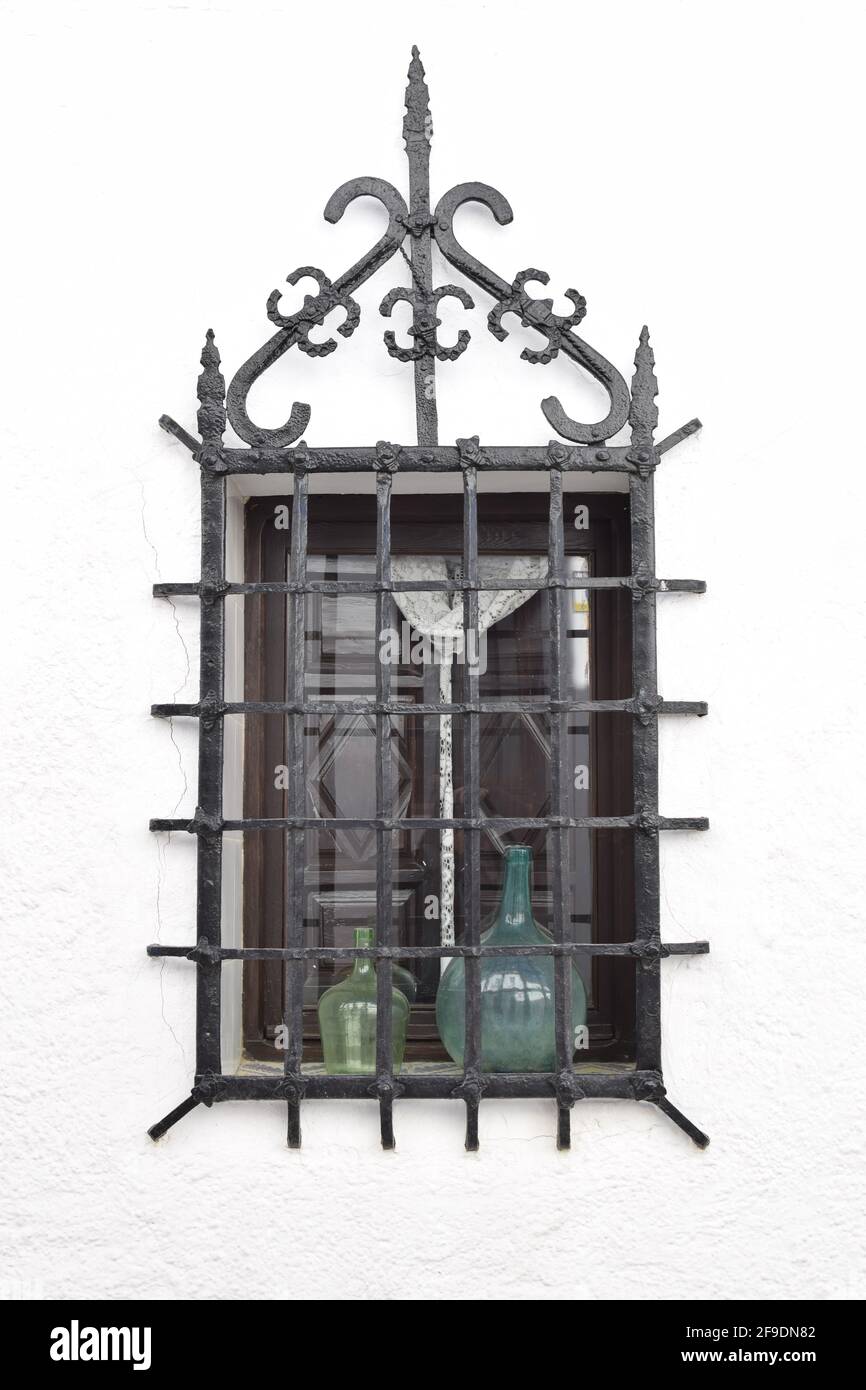 A vertical shot of an 18th century wrought iron window isolated on a ...