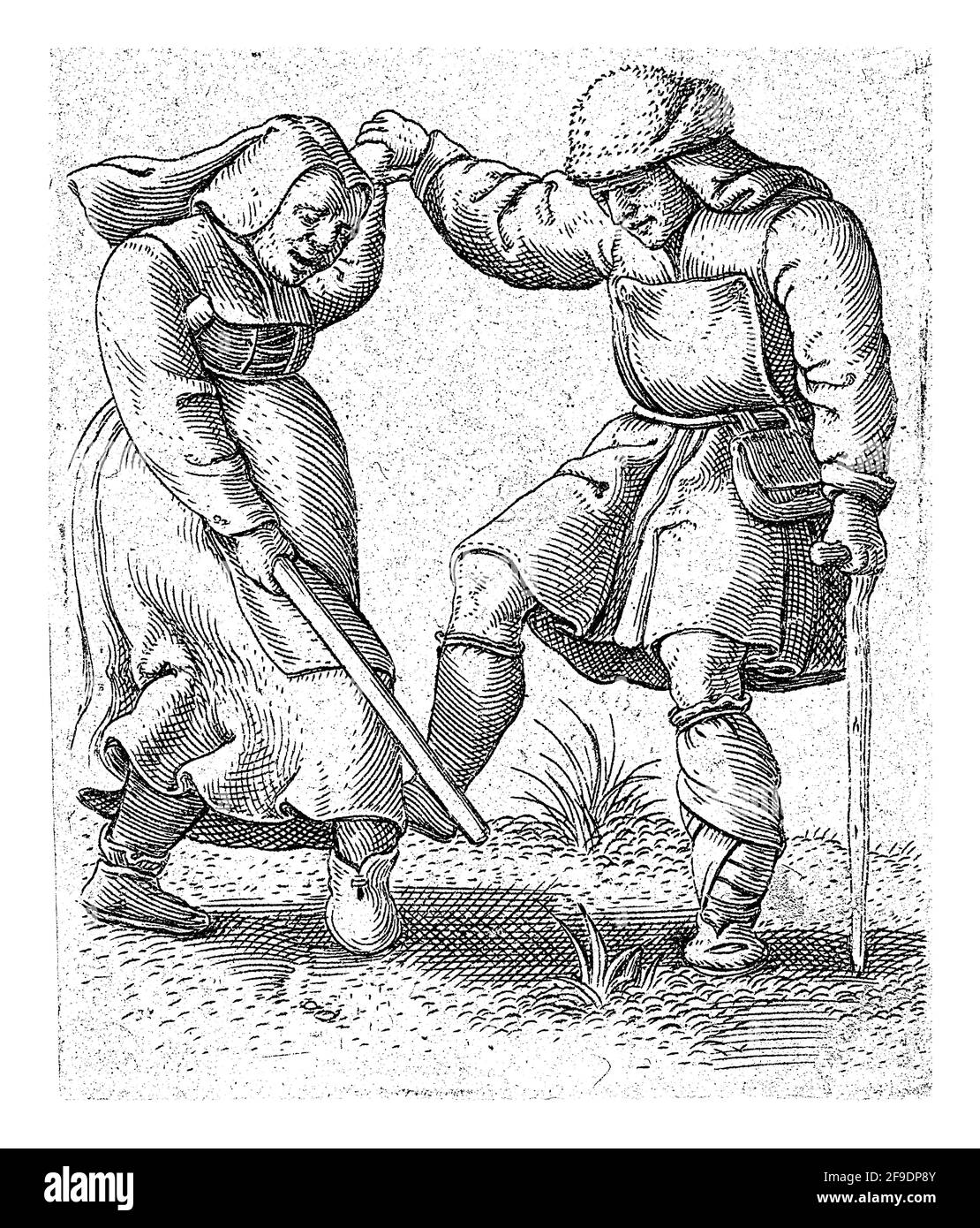 A woman and a man dressed as farmers dance and hold hands. The woman is holding a stick in the other hand and the man is leaning on a crutch. Stock Photo