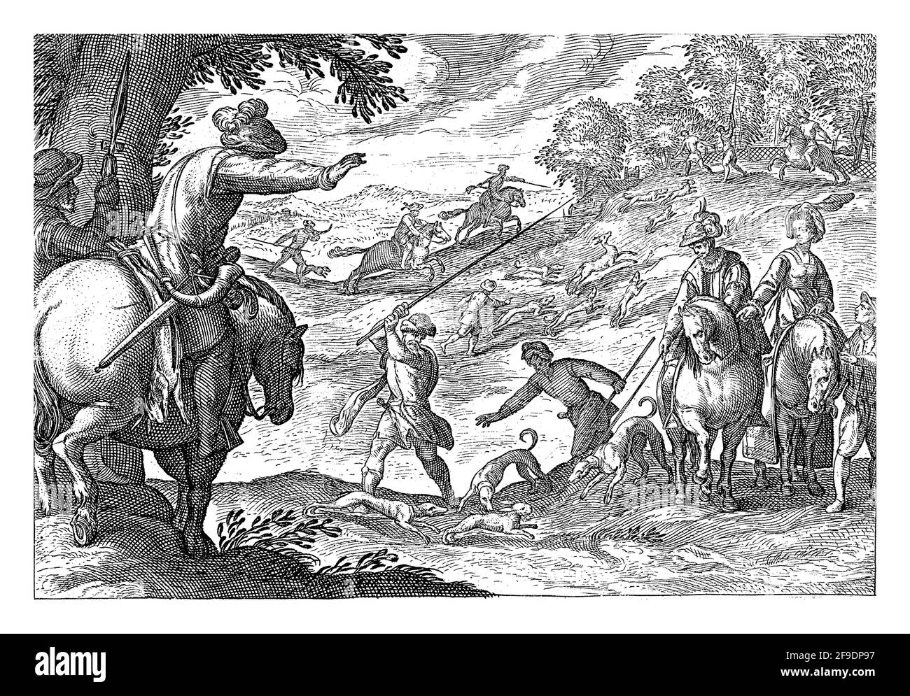 Hilly landscape with riders, hunters and dogs on a hare hunt. In the left foreground, a rider and a man with a spear, seen from the back Stock Photo