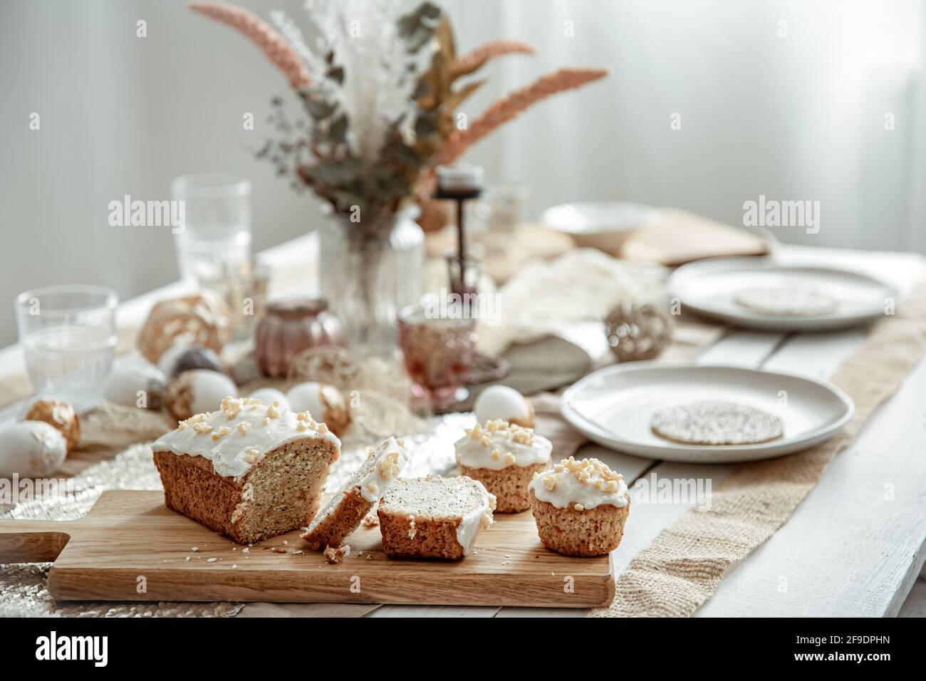 A festive table with a beautiful setting and freshly baked Easter cake. Stock Photo