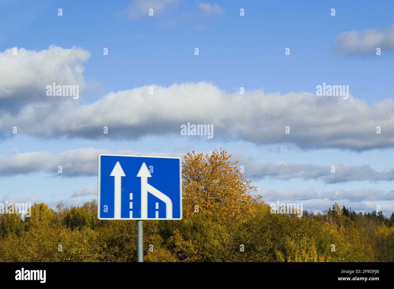 A close-up shot of a road sign on the blue sky background Stock Photo ...
