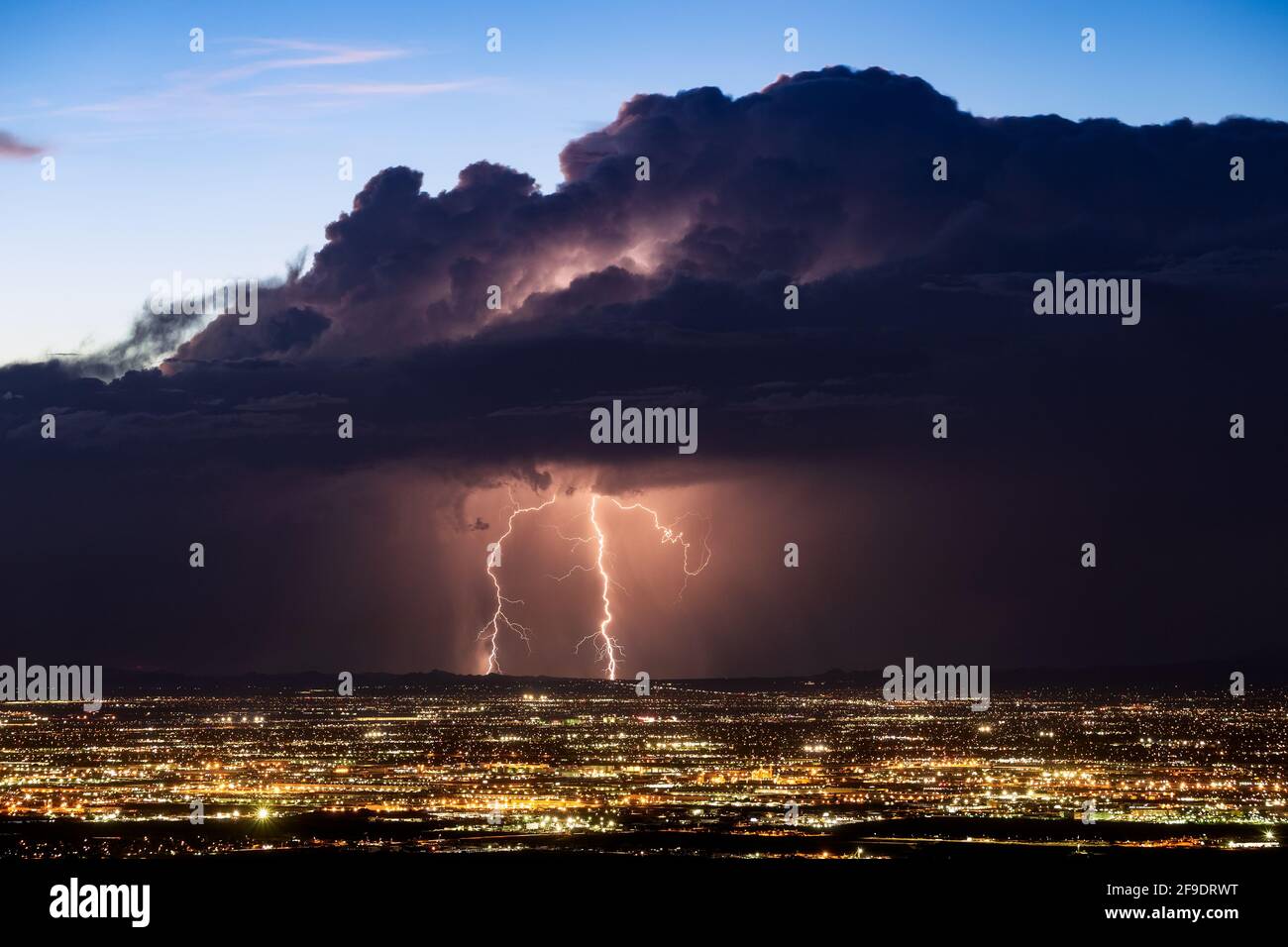 Lightning strikes from a monsoon thunderstorm over Phoenix, Arizona Stock Photo
