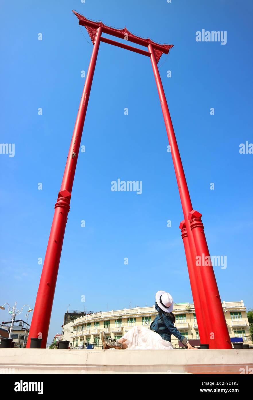 Woman in Hat Looking Up to the Giant Swing Called Sao Ching Cha, Old Teak Wood Swing Used in