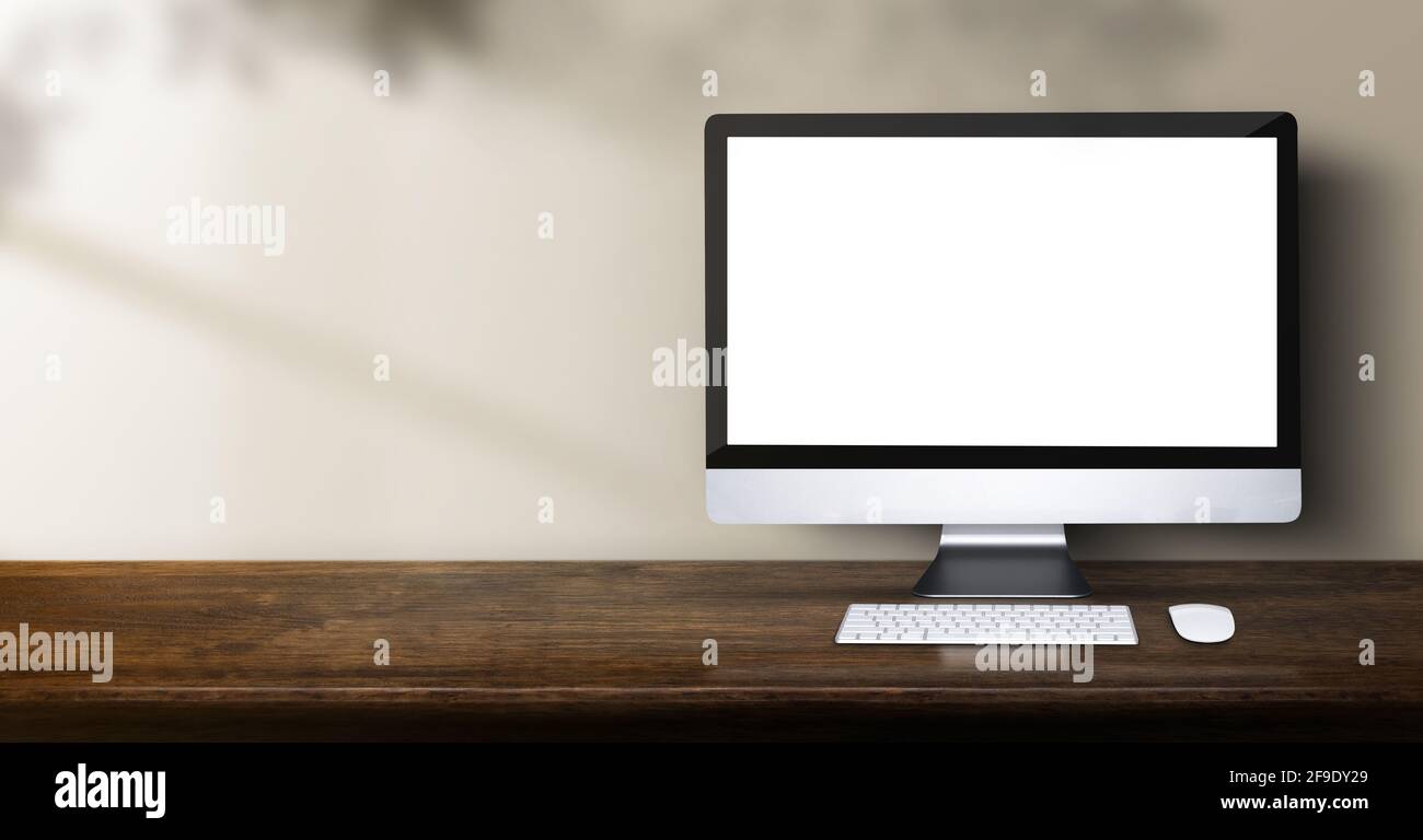 desktop computer on wood table backgorund with sunlight window create ...