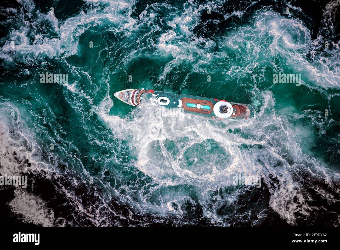 Storm waves of the sea around the ship. Stock Photo