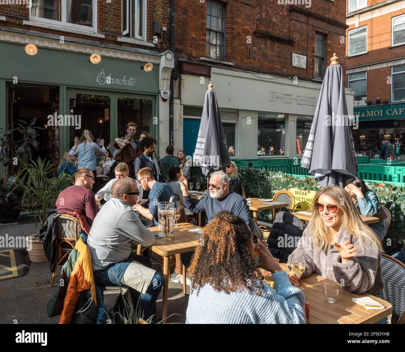 London, UK. 18th Apr, 2021. Diners seen sitting in the streets outside