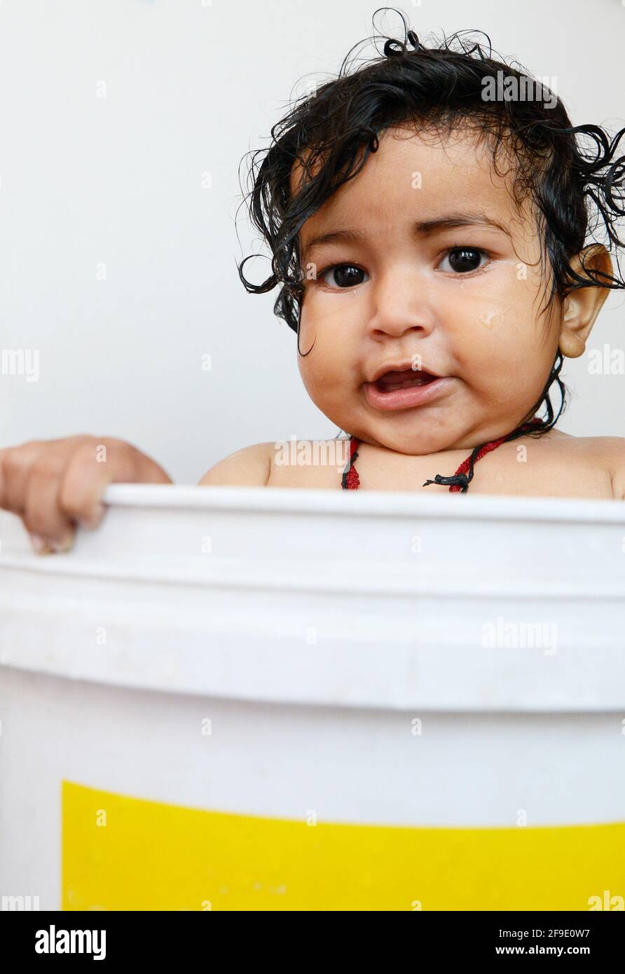 Baby having fun in the bathtub (Bucket Stock Photo Alamy