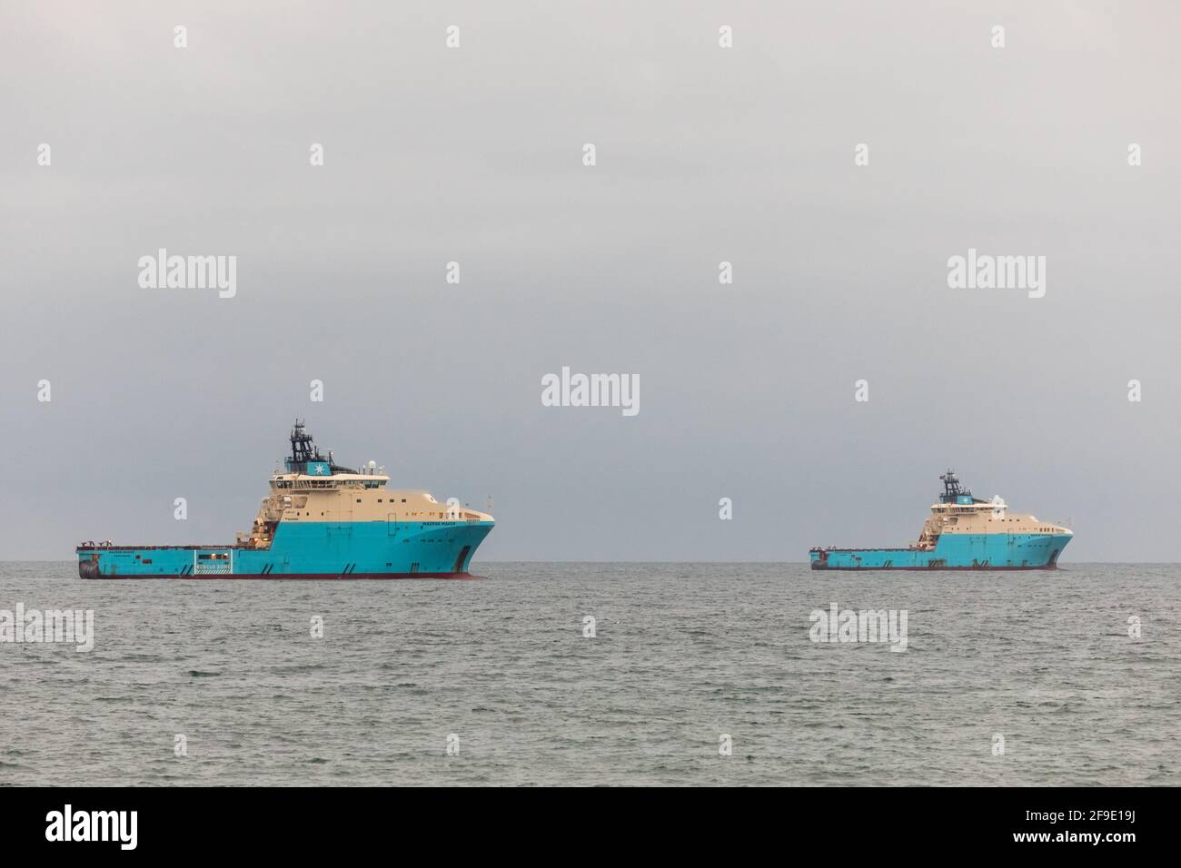 Myrtleville, Cork, Ireland. 18th April, 2021. Danish registered offshore supply ships Maersk Maker and Maersk Mariner lie at anchor off Myrtleville, Co. Cork. The tugs were used to tow the giant rig Stena Spey to the Kinsale gas field from Scapa Flow, UK and will used in subsea well plugging and decommissioning of the gas field.    - Credit David Creedon / Alamy Live News Stock Photo