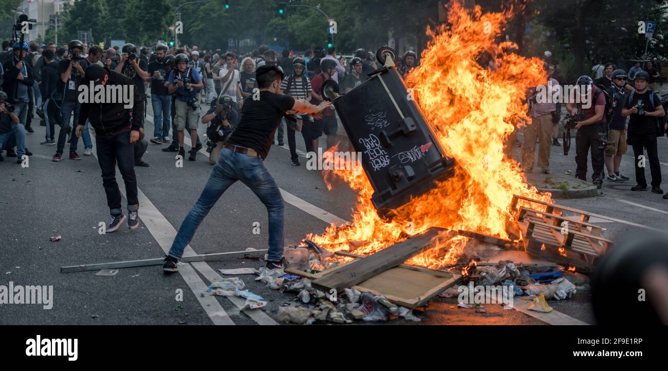 Sternschanze Hamburg, Germany - July 7, 2017: Protester throws trash into fire during g20 riots Stock Photo